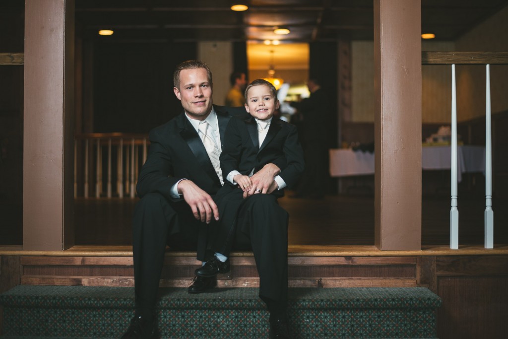 Father and son sitting together with Tom Studios Wedding Photography 