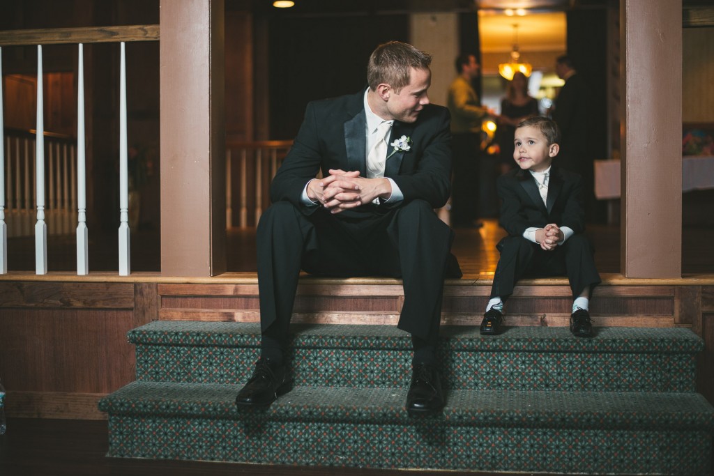 Father and Son sitting together with Tom Studios Wedding Photography 